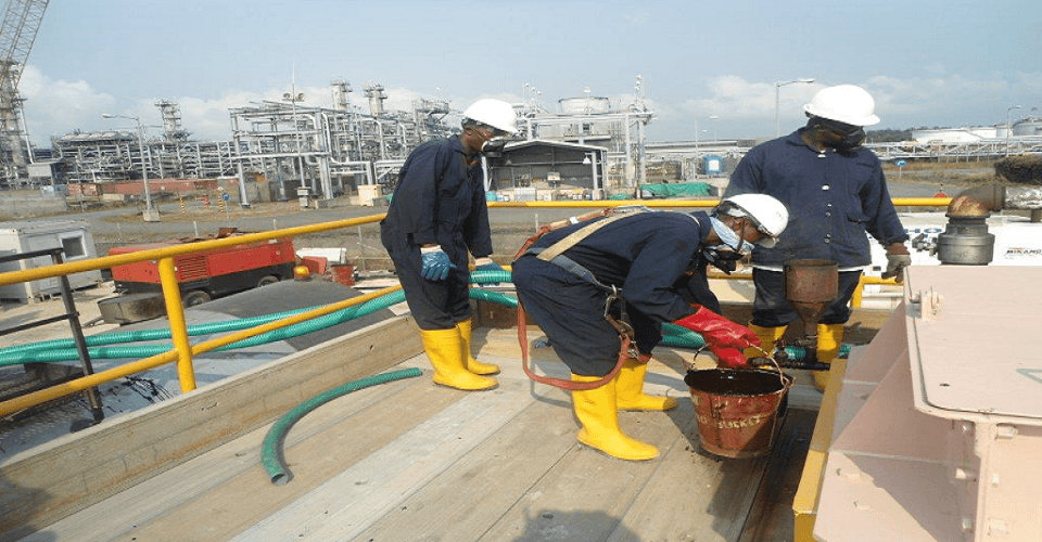 Field personnel working safely on top of an industrial tanker